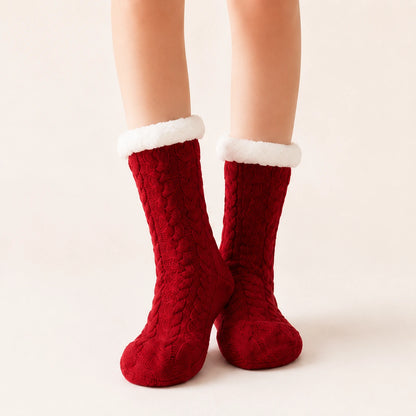 Red sherpa-lined slipper socks worn on feet
